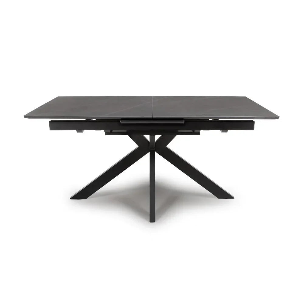 Rectangular black dining table with ceramic top and crossed metal legs, front view
