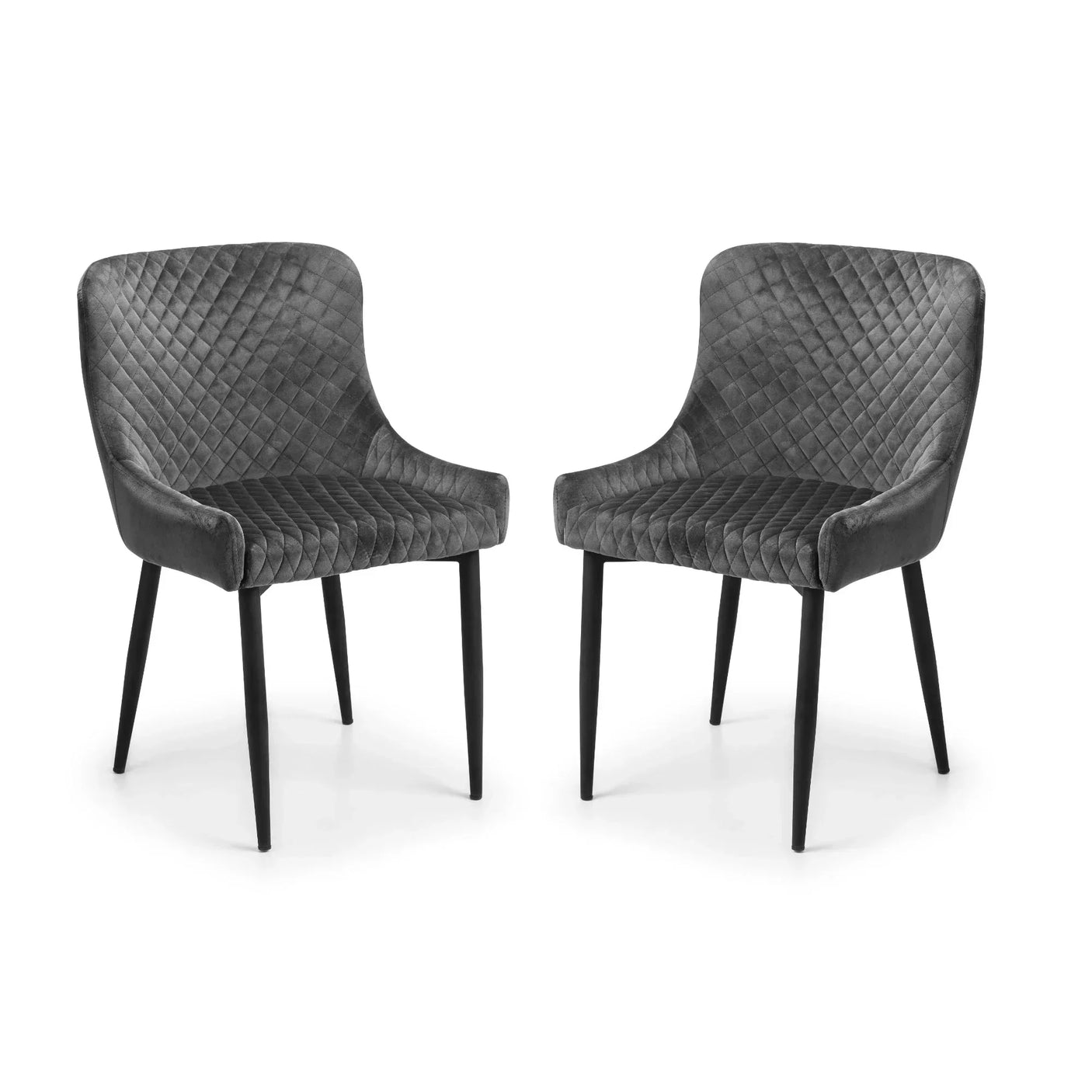 Pair of grey velvet dining chairs with quilted backs and black legs on white background