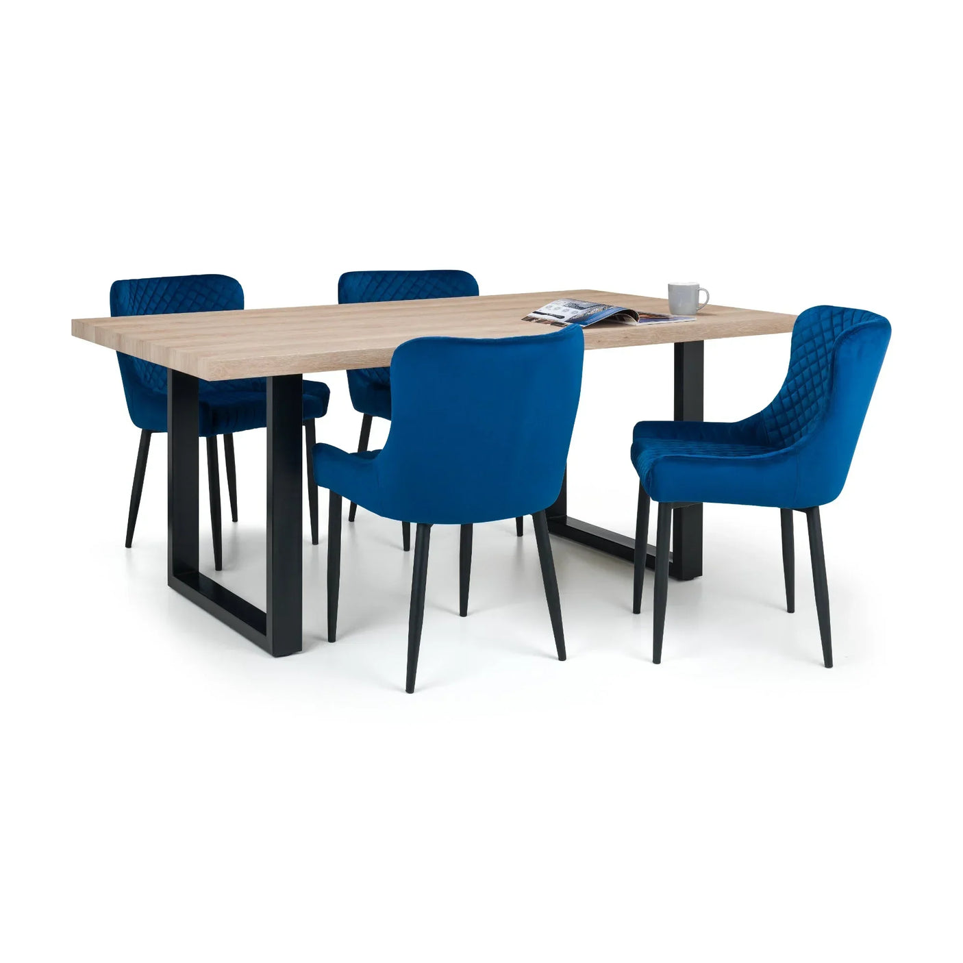 Blue velvet dining chair with quilted backrest around wooden dining table