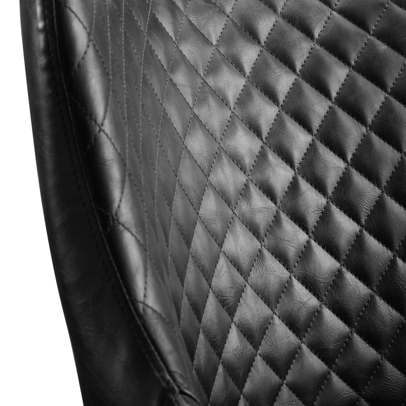 Close-up of Luxe faux leather dining chair with diamond quilted stitching in black