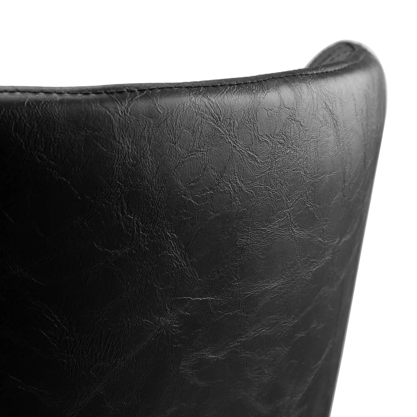 Closeup of Luxe faux leather dining chair backrest in black finish