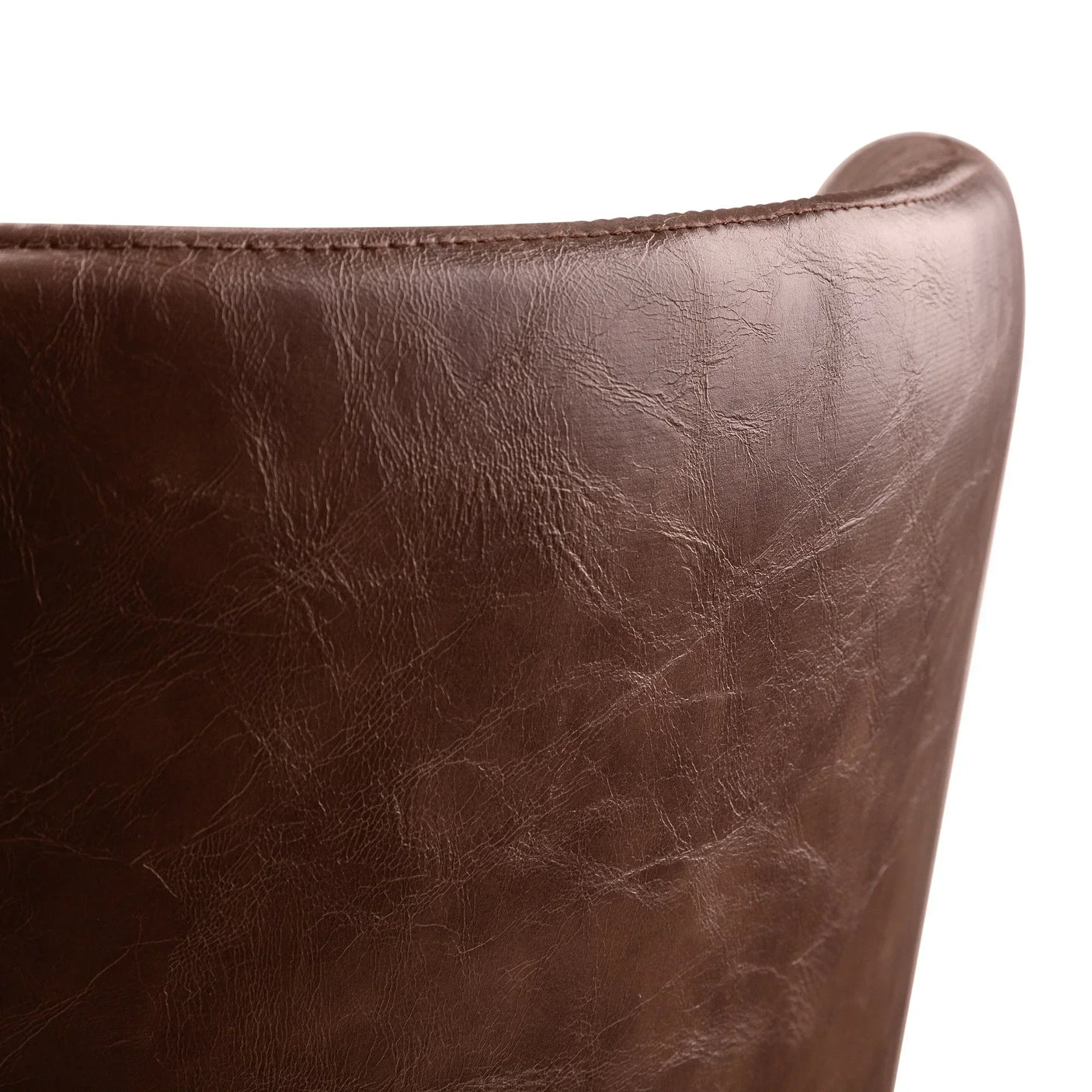 Close-up of brown faux leather dining chair backrest with textured stitching detail