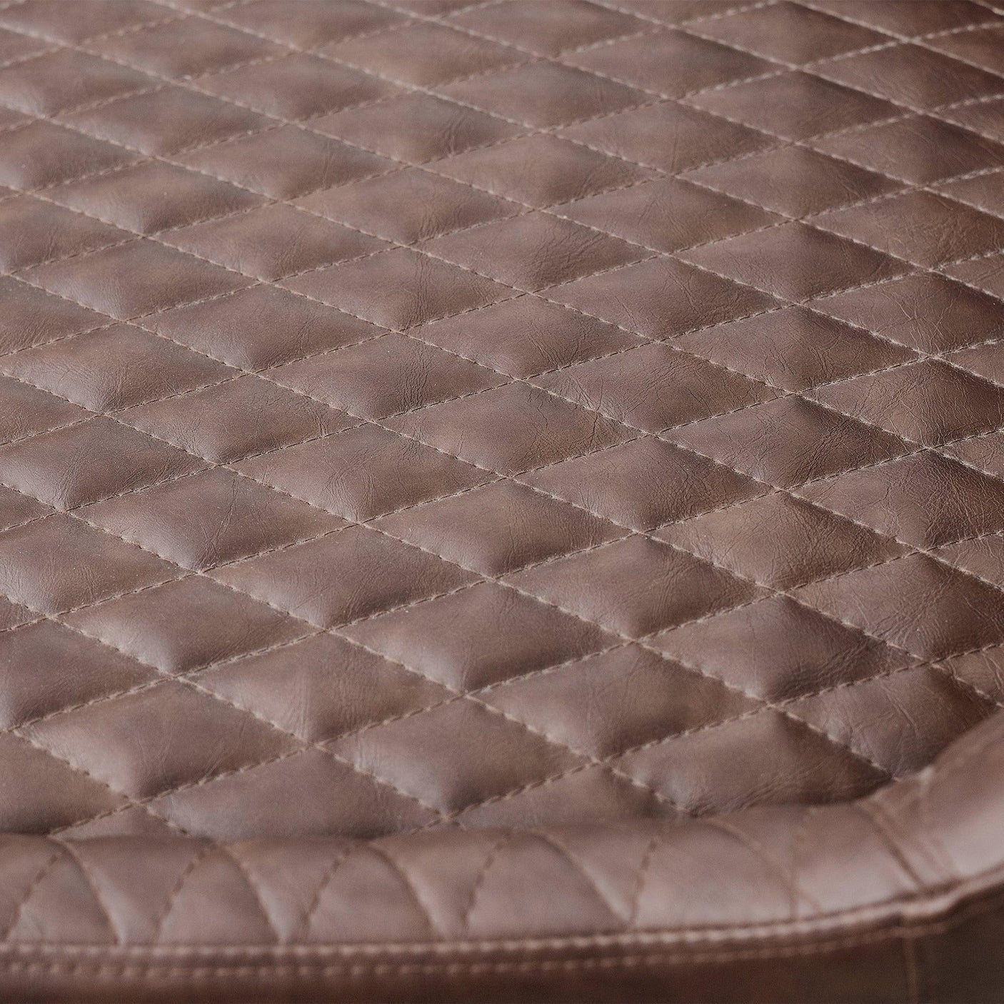 Brown faux leather office chair with quilted diamond stitch seat detail