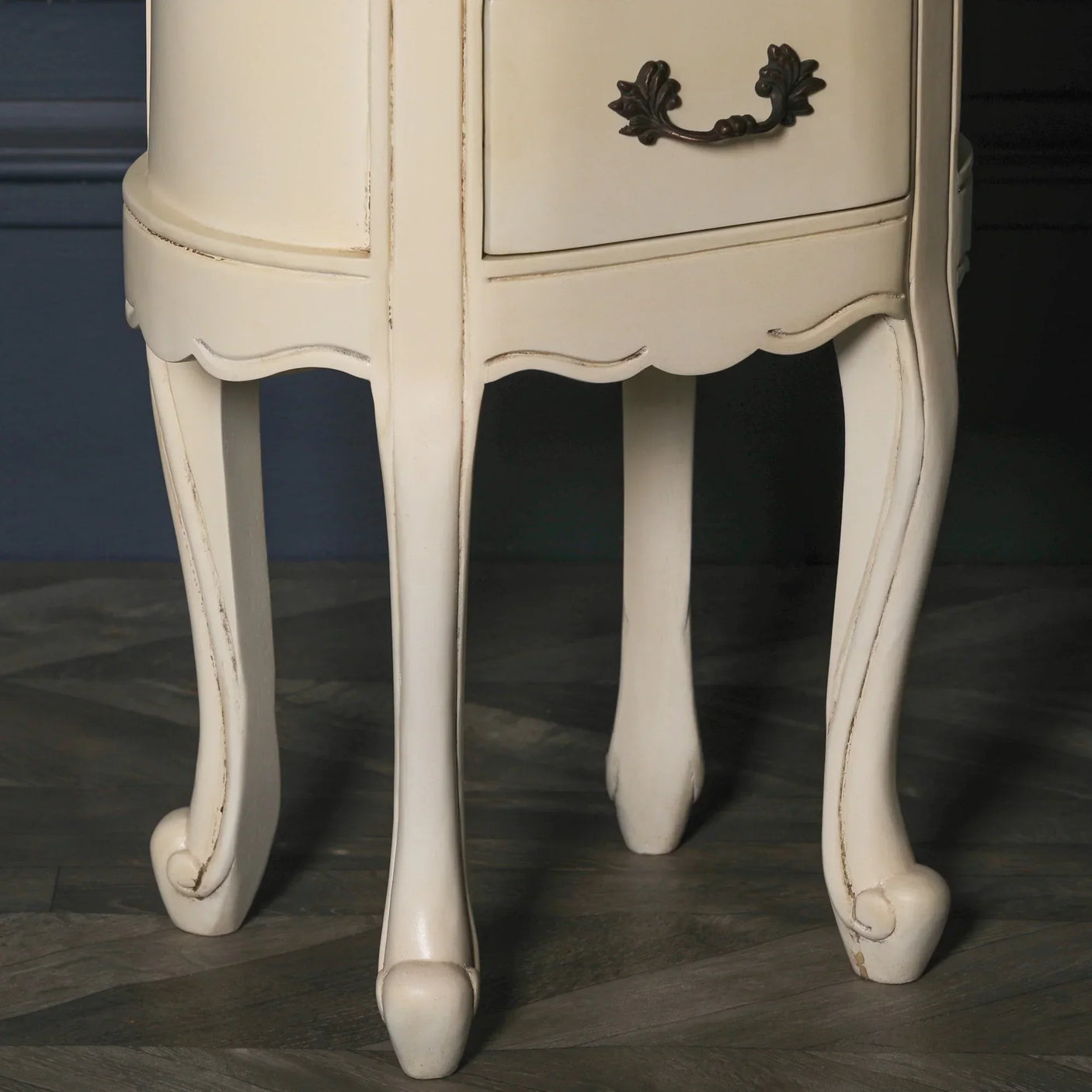 Cream painted bedside table with curved cabriole legs and ornate metal drawer handle