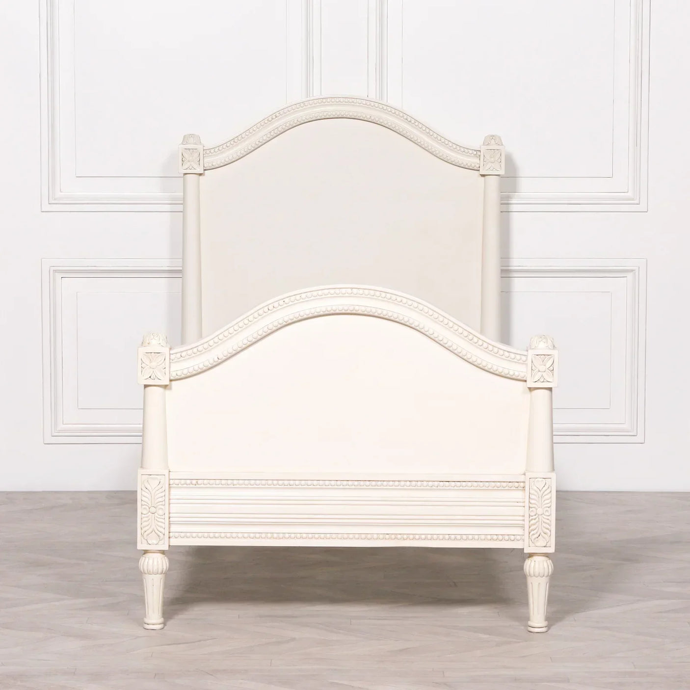 Cream wooden bed frame with carved detailing and curved headboard, shown from the front
