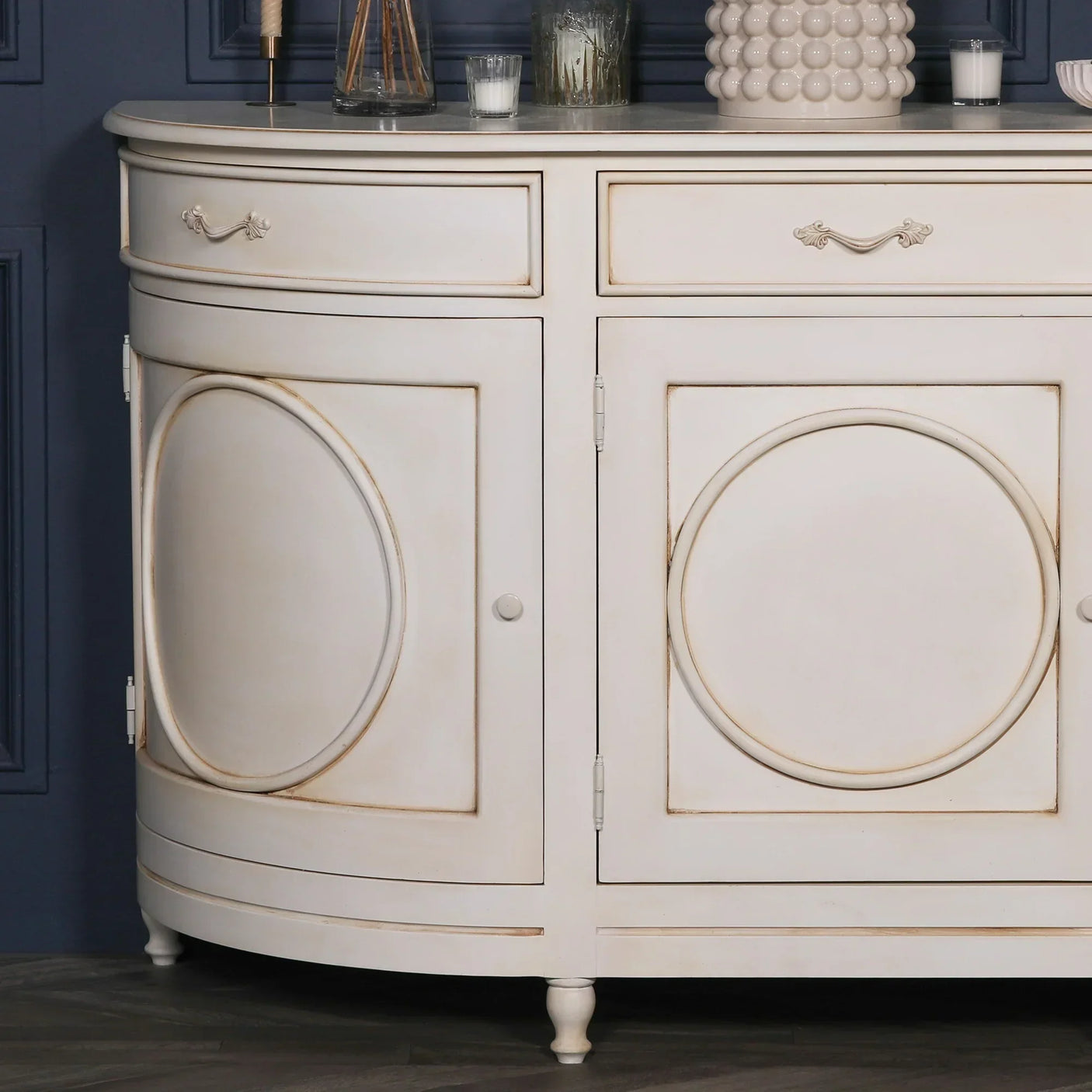 Cream wood sideboard with curved doors, circular panel detail and vintage handles