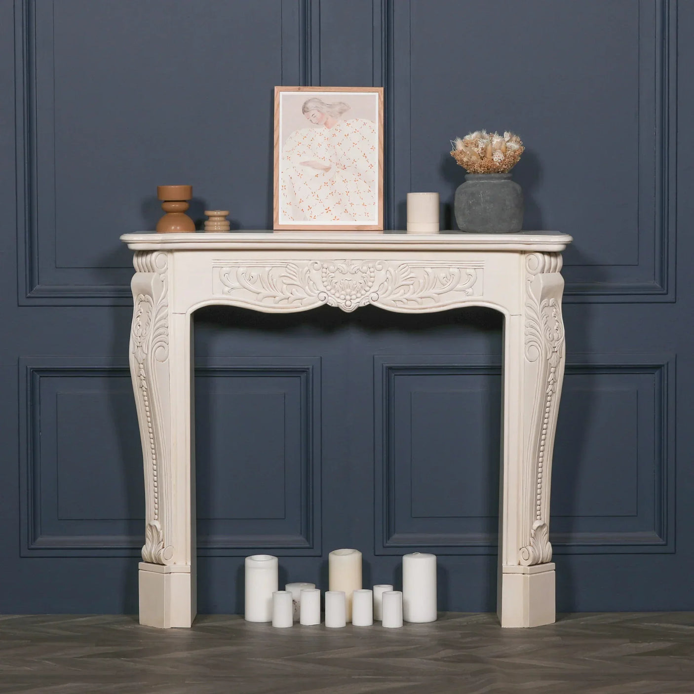 Cream ornate wooden console table with carved detailing against navy panel wall