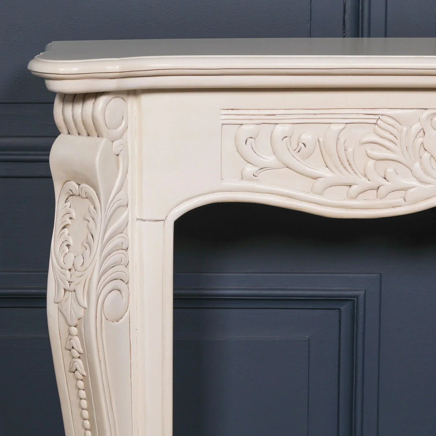 Cream wood console table with ornate carved detailing and curved leg design