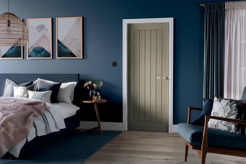 Light grey internal door with vertical panels in modern blue bedroom setting