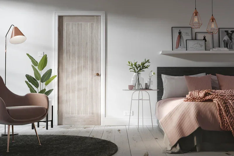 Light grey laminate Mexicano door in modern bedroom with blush accents and wall art