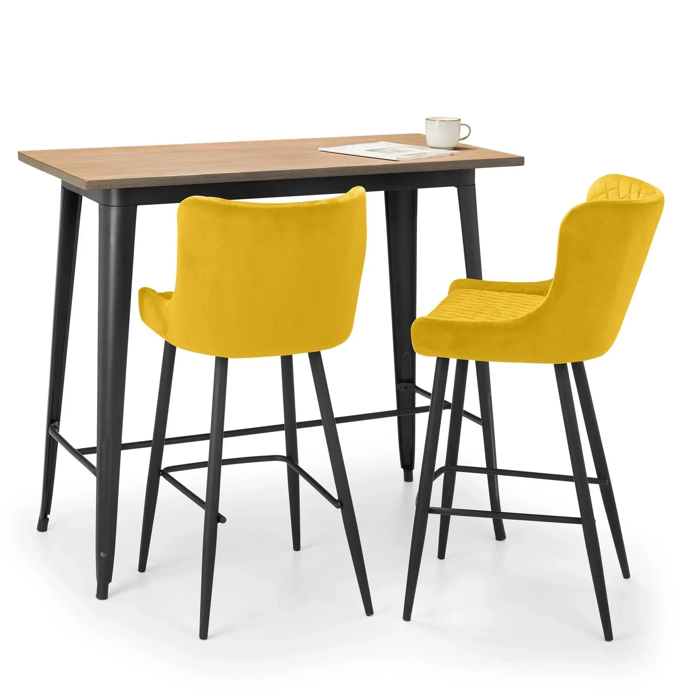 Mustard bar stools with velvet upholstery and black legs at a rectangular bar table