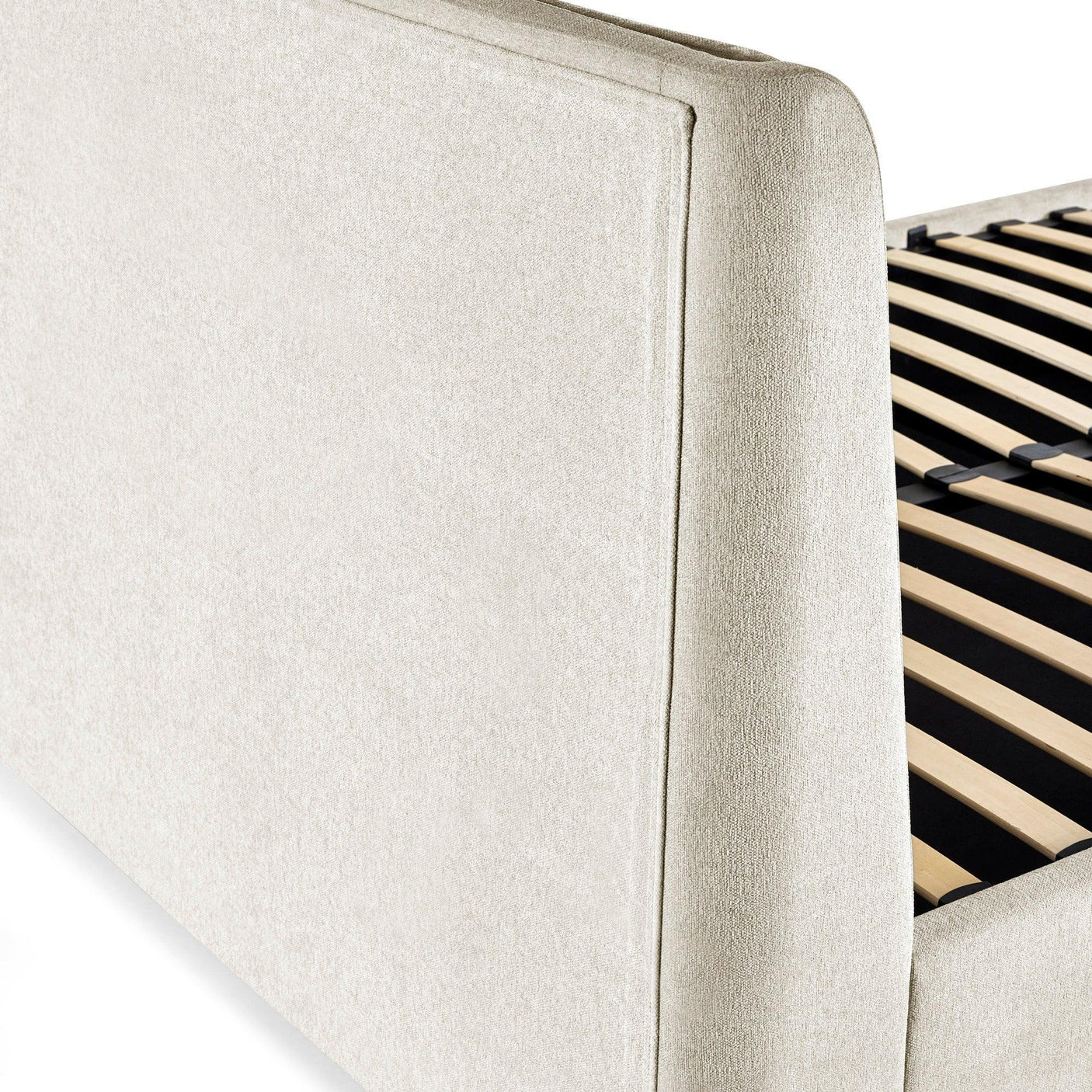 Beige upholstered bed frame with wooden slats, closeup of headboard and side panel