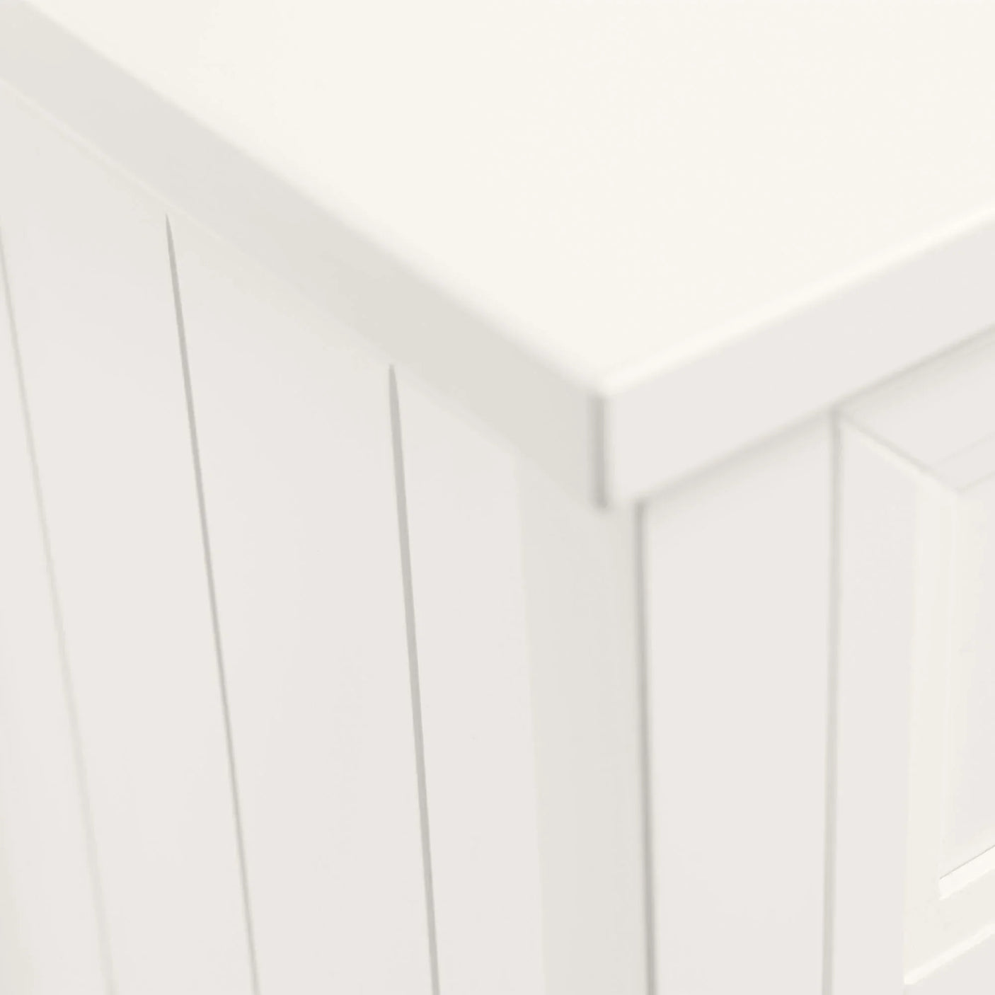 Corner detail of Maine white chest with paneled finish and smooth surface