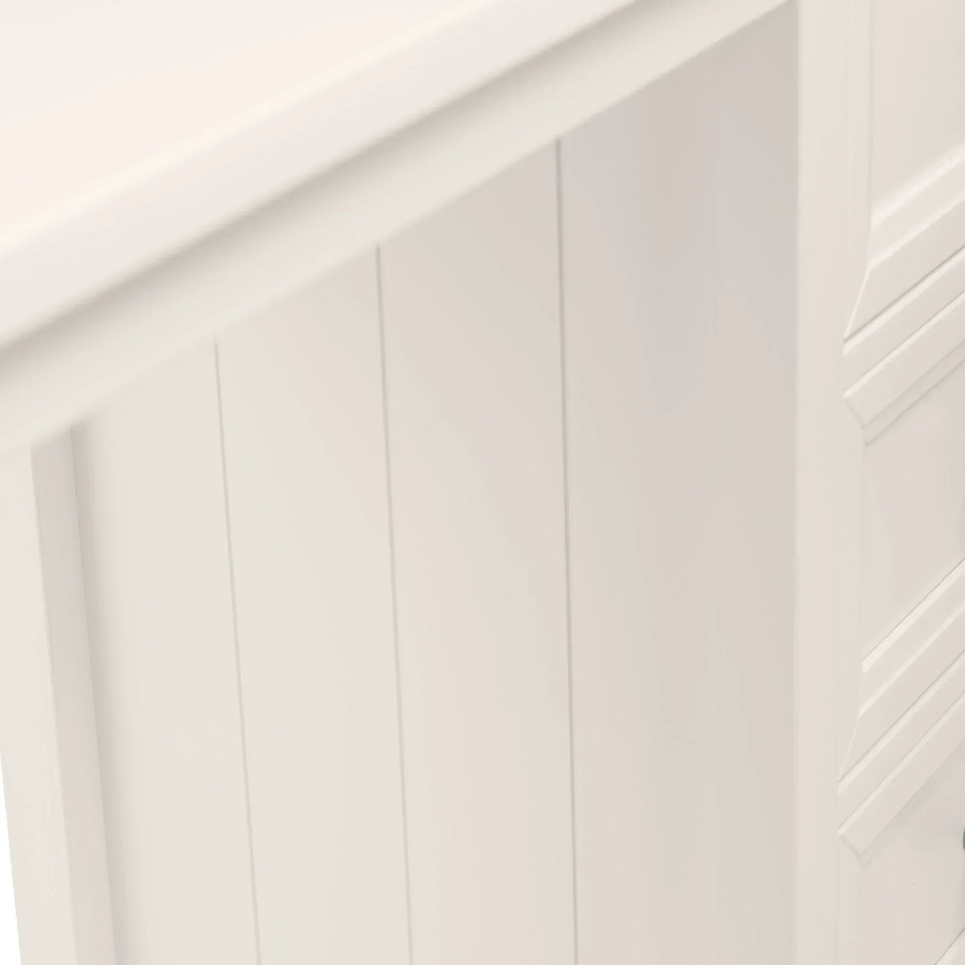 White wooden sideboard with vertical panel detail and smooth painted finish, close-up view