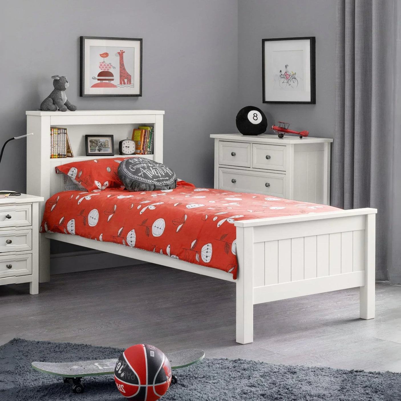White wooden single bed with shelf headboard in modern bedroom, red bedding, matching drawers