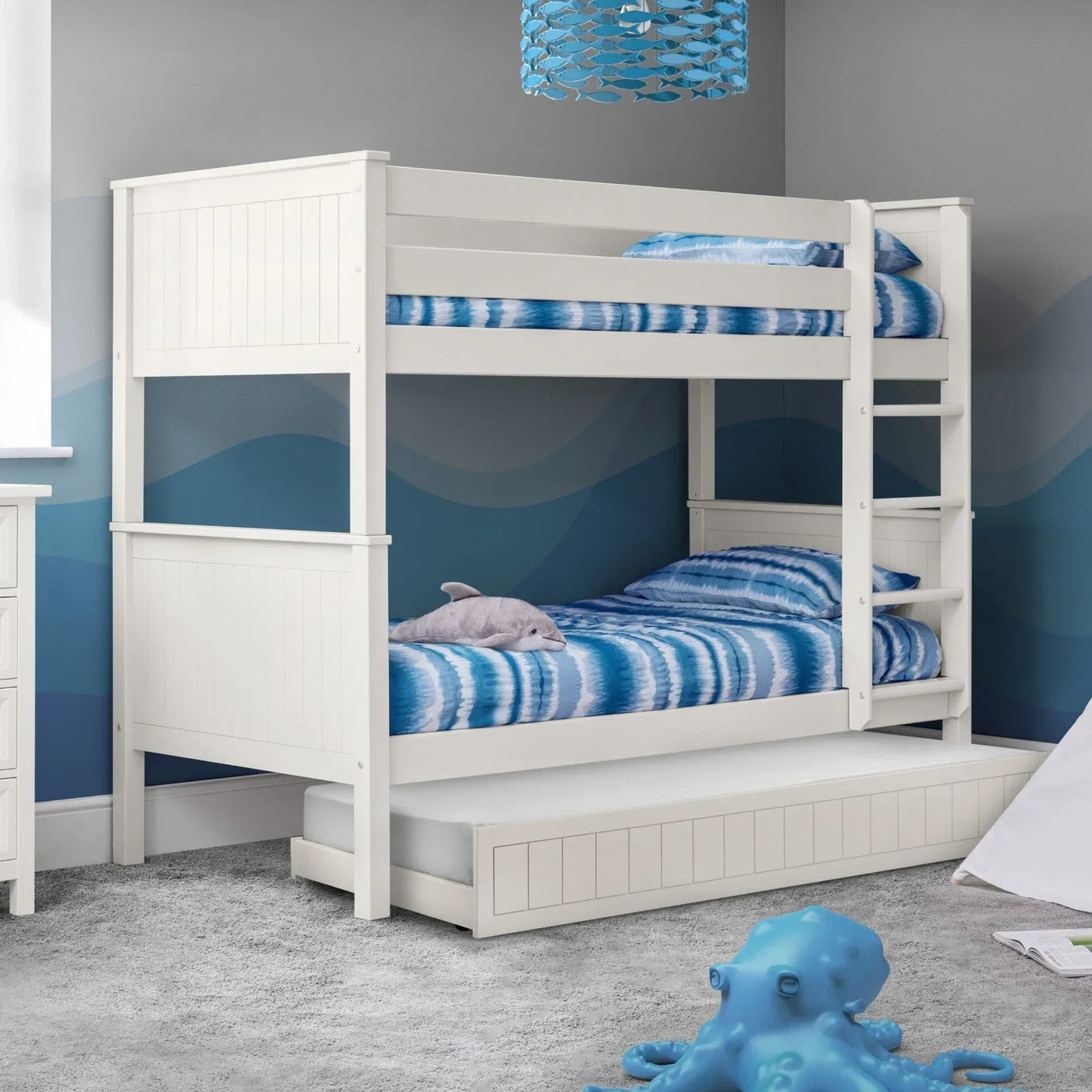 White wooden bunk bed with built-in ladder and underbed storage drawer in kids' bedroom