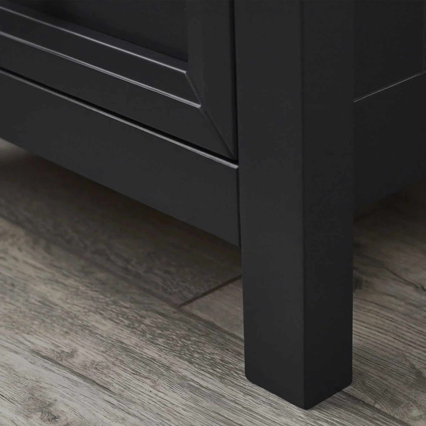 Anthracite bedside table leg and lower panel detail on wood floor
