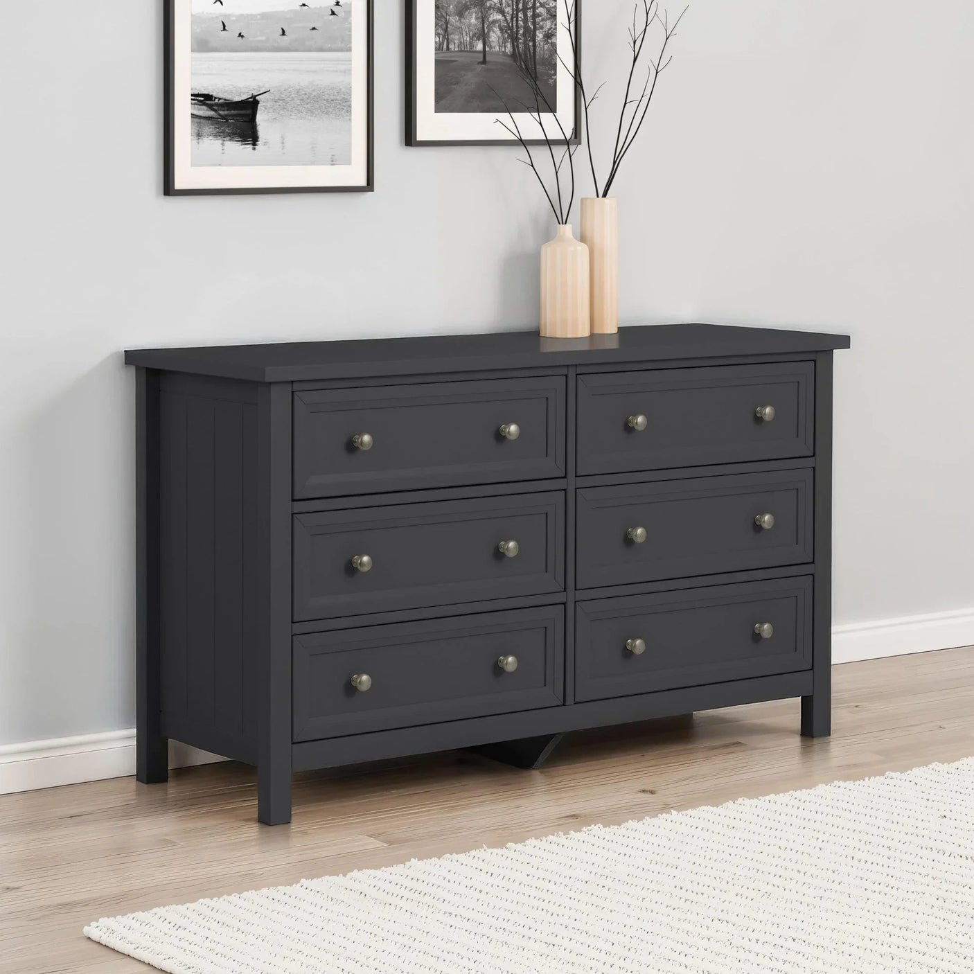 Charcoal six drawer chest with round handles in modern bedroom setting
