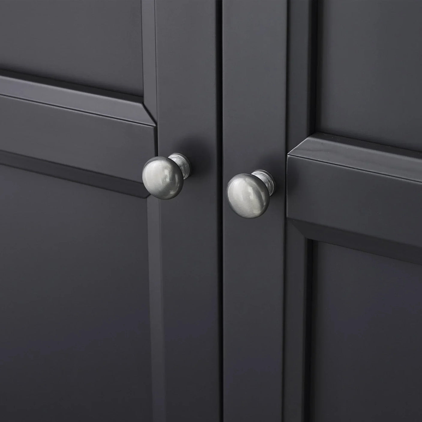 Anthracite wardrobe door closeup showing metal knobs and panel detailing