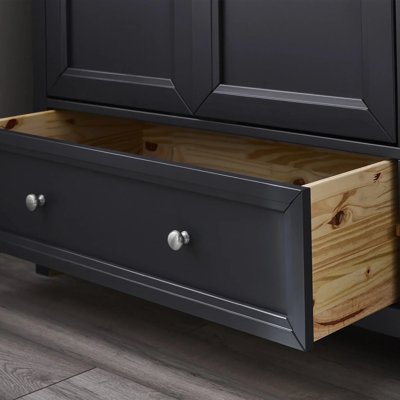 Anthracite wardrobe lower drawer open showing pine wood interior and silver handles