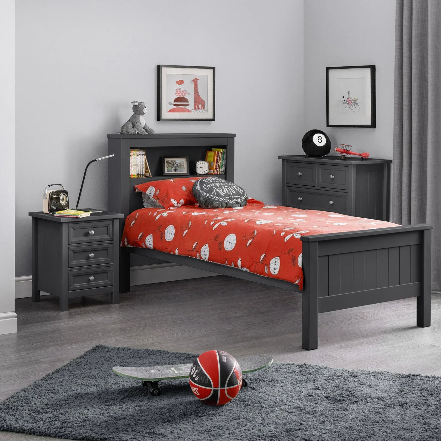 Grey wooden single bed with storage headboard and red bedding in kids bedroom set up