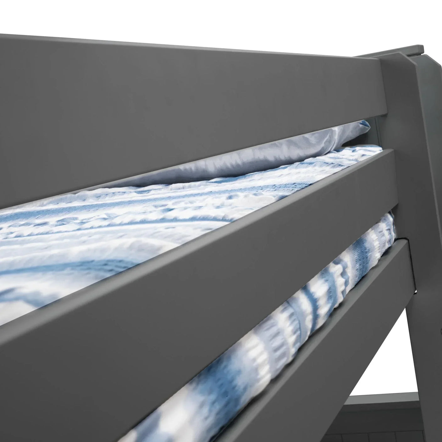 Side detail of grey bunk bed with safety rails and blue patterned bedding