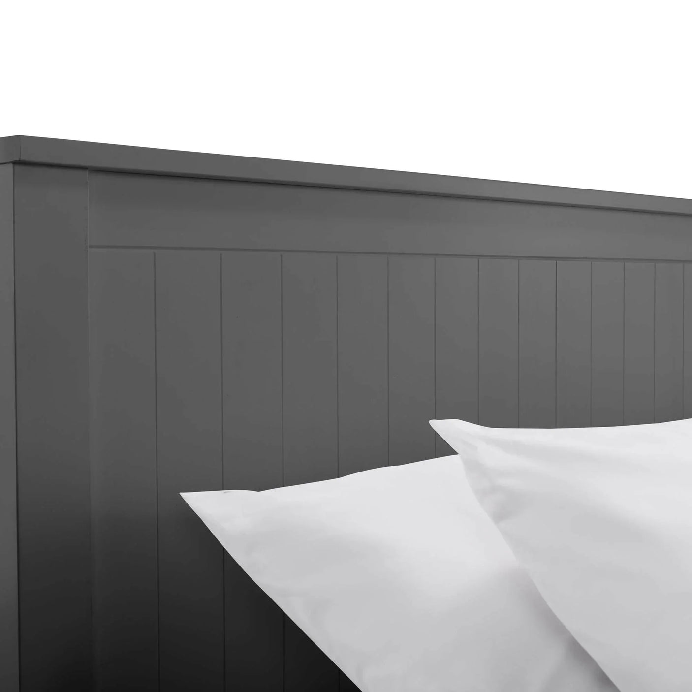 Grey wooden bed frame headboard with vertical panel detail, white pillows in foreground