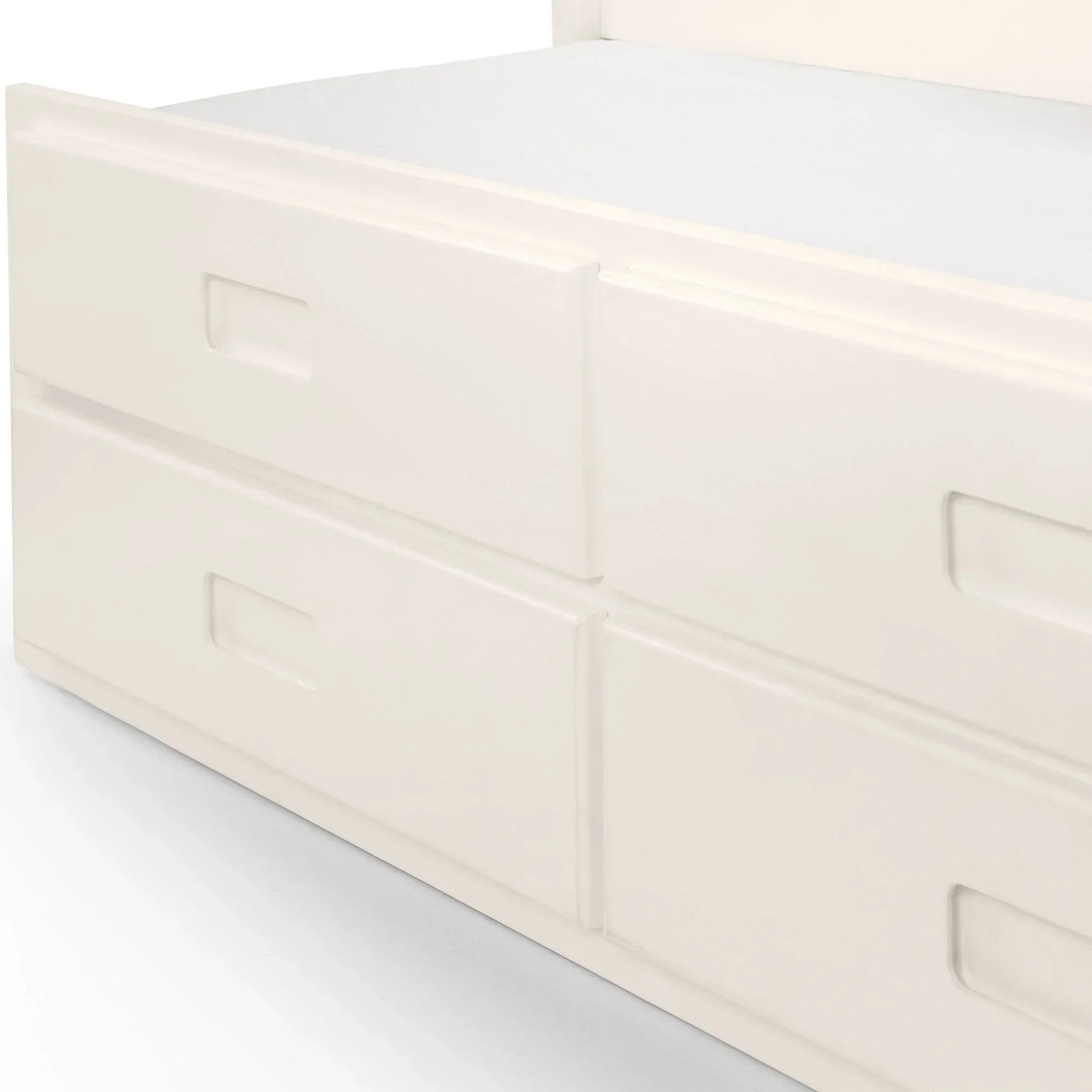 White single daybed with built-in storage drawers, close-up of drawer handles and base