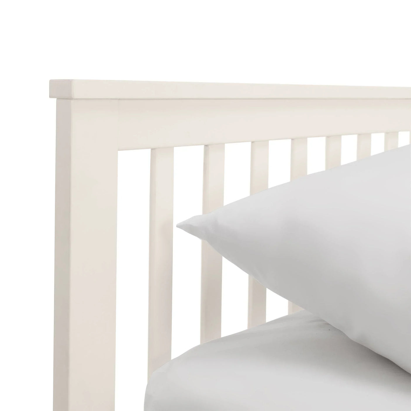 White single daybed frame with vertical slats and white bedding detail view