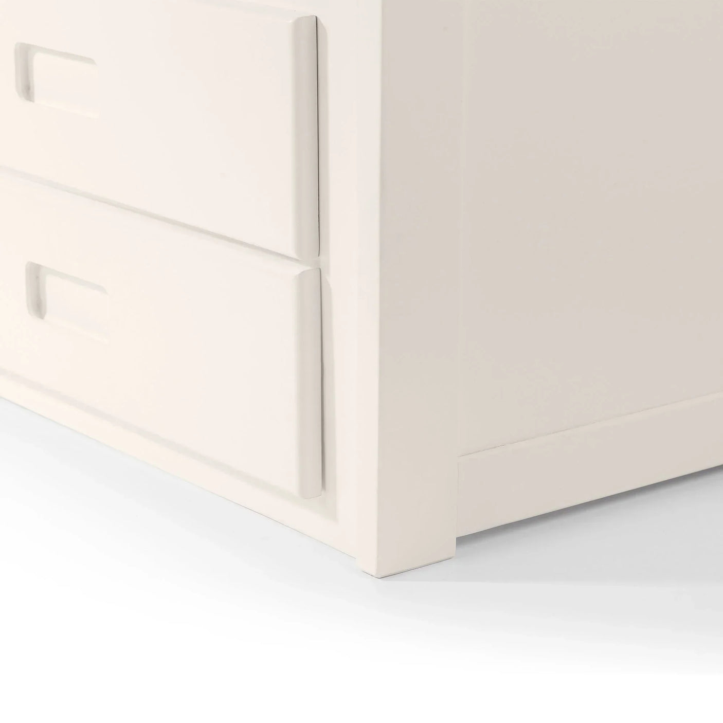 White daybed storage drawers with inset handles, close-up of corner and drawer detail