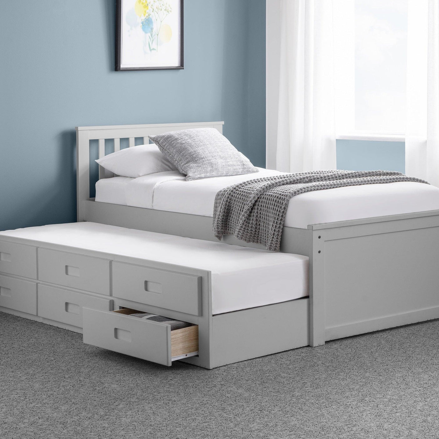 Light grey daybed with pull-out trundle bed and storage drawers in a modern bedroom