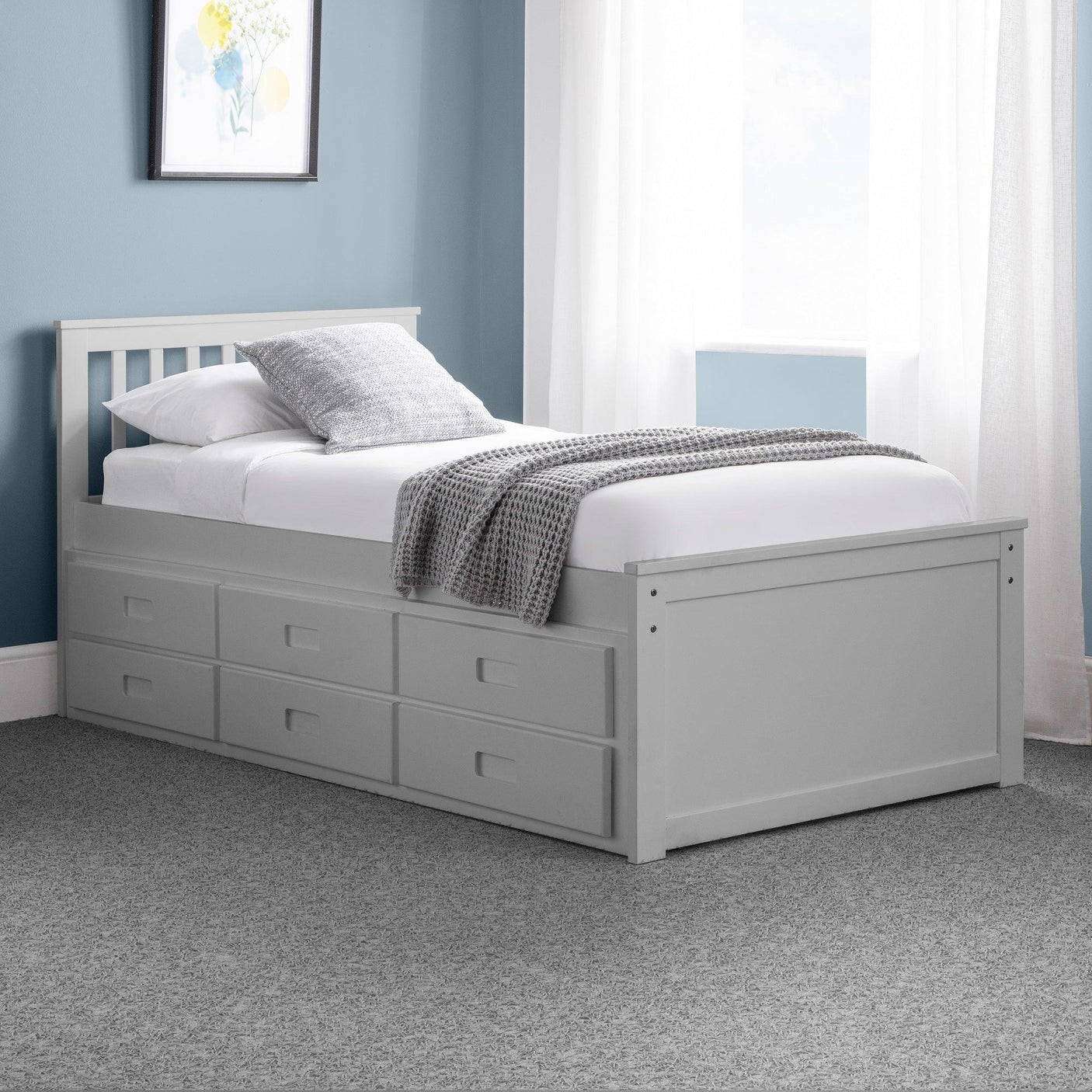 Light grey single daybed with storage drawers in a modern bedroom setting