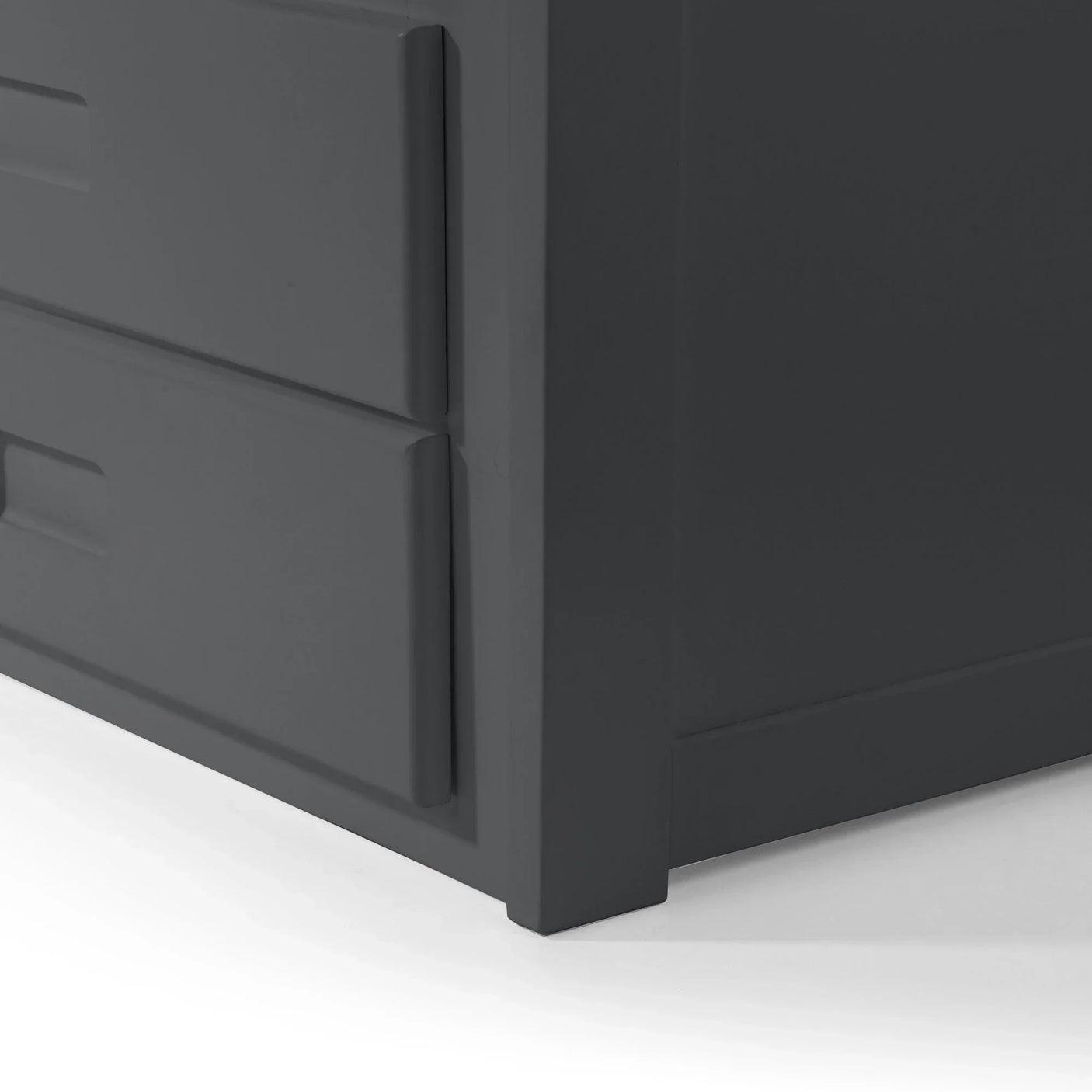 Closeup of charcoal grey chest of drawers corner showing modern handle detail