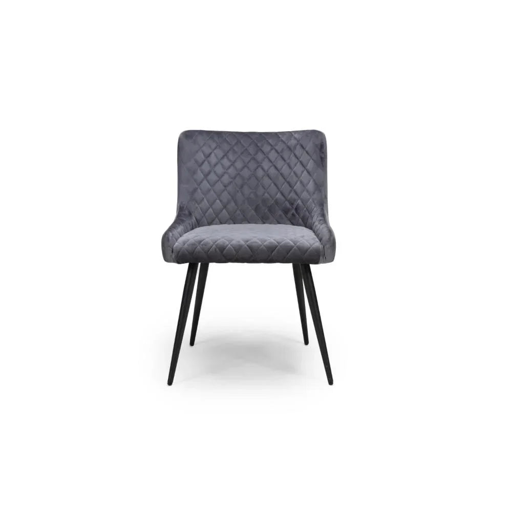 Grey upholstered dining chair with quilted seat, black metal legs, front view