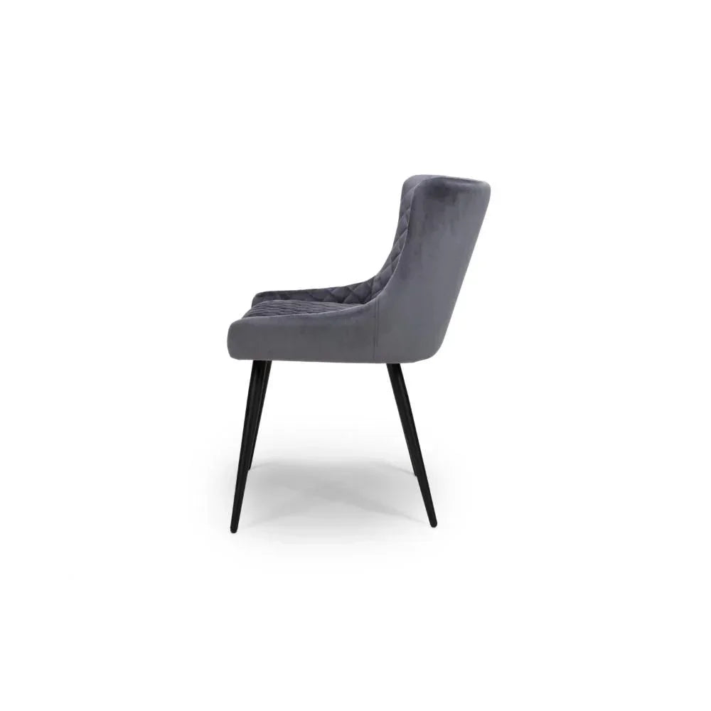 Grey velvet dining chair side view with black metal legs