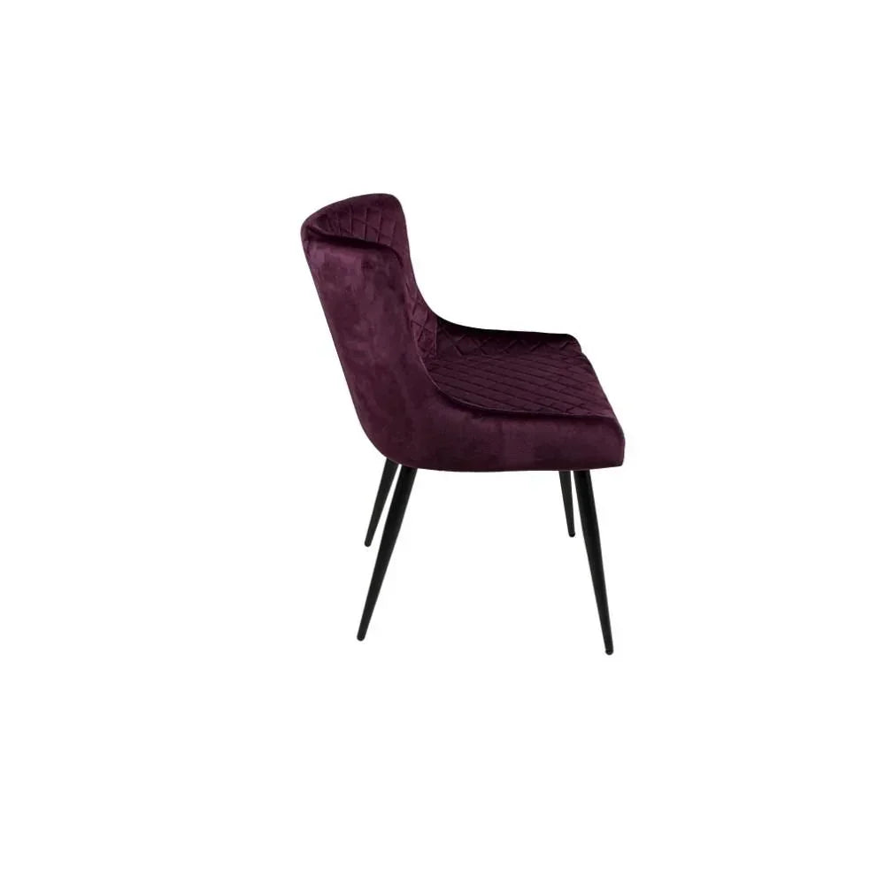 Plum velvet dining chair with quilted seat and black metal legs side profile