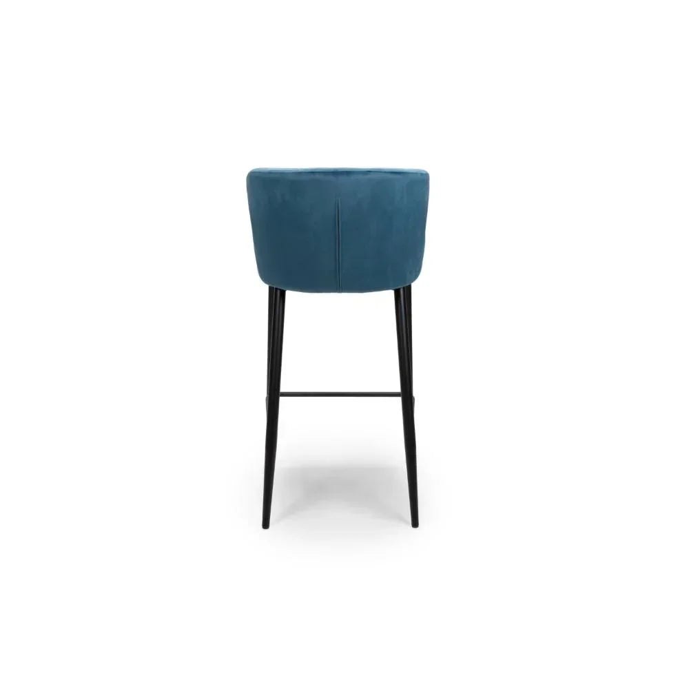 Blue velvet bar stool with black metal legs, rear view showing curved backrest