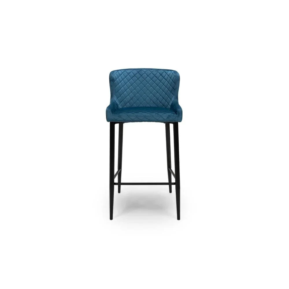 Blue velvet bar stool with quilted backrest and black metal legs, front view