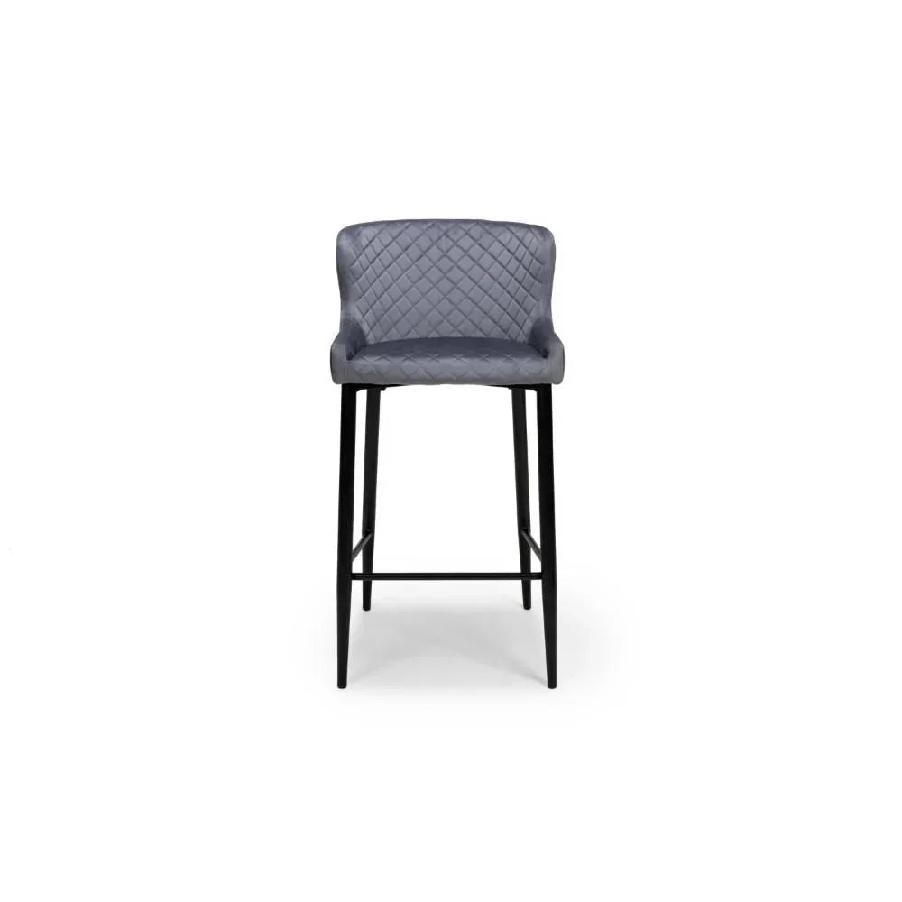 Grey velvet bar stool with quilted backrest and black metal legs, front angle view
