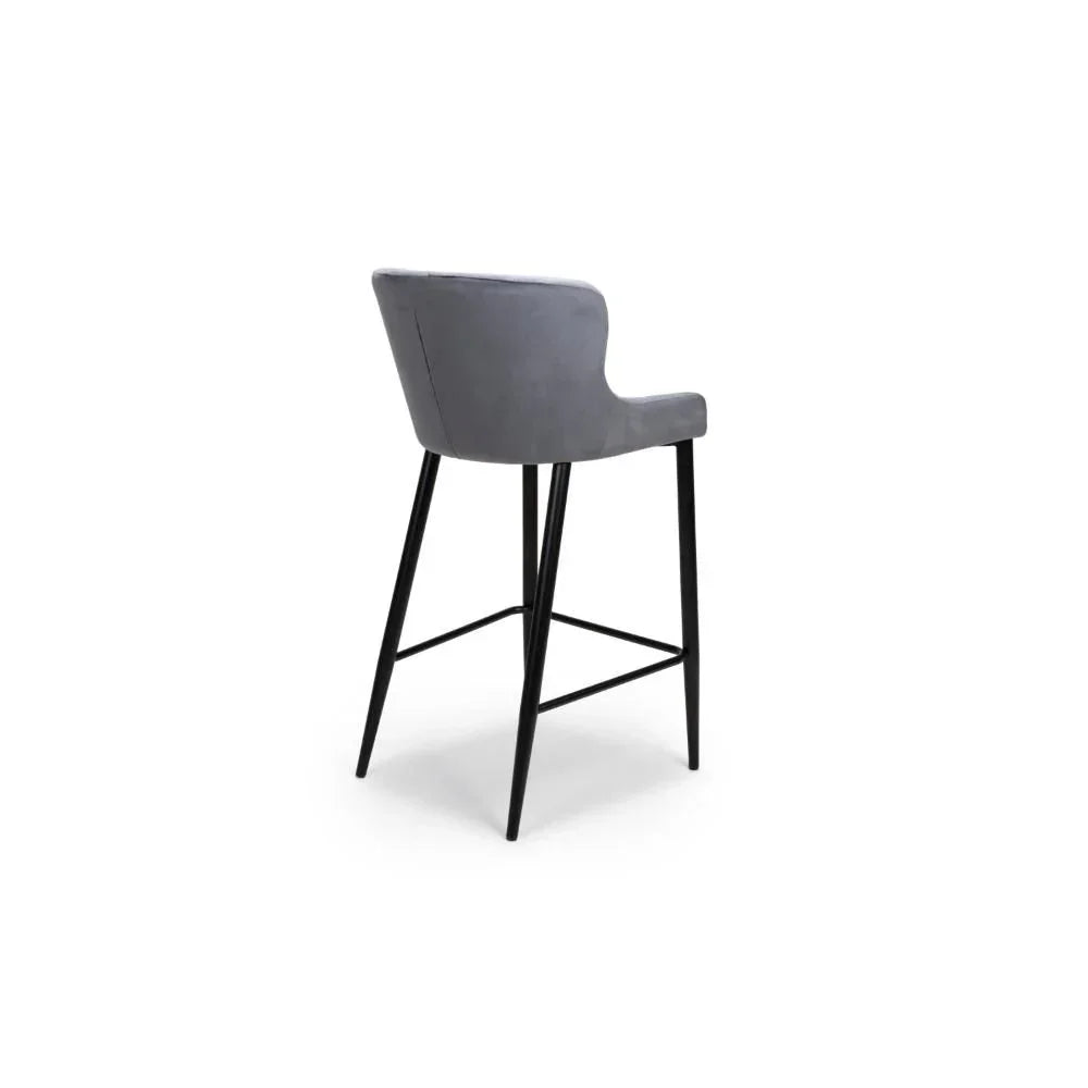Grey upholstered bar stool with curved backrest and black metal legs, rear view
