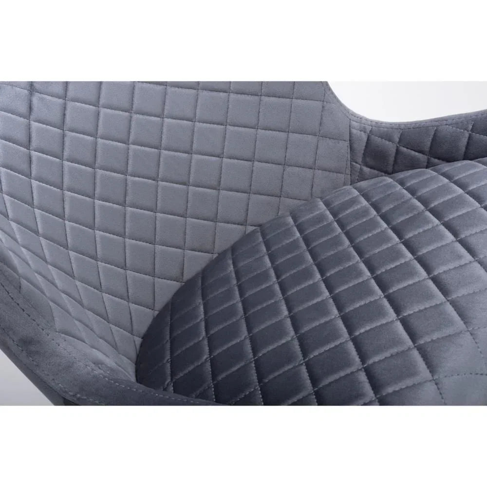 Grey velvet dining chair with quilted seat and backrest close-up