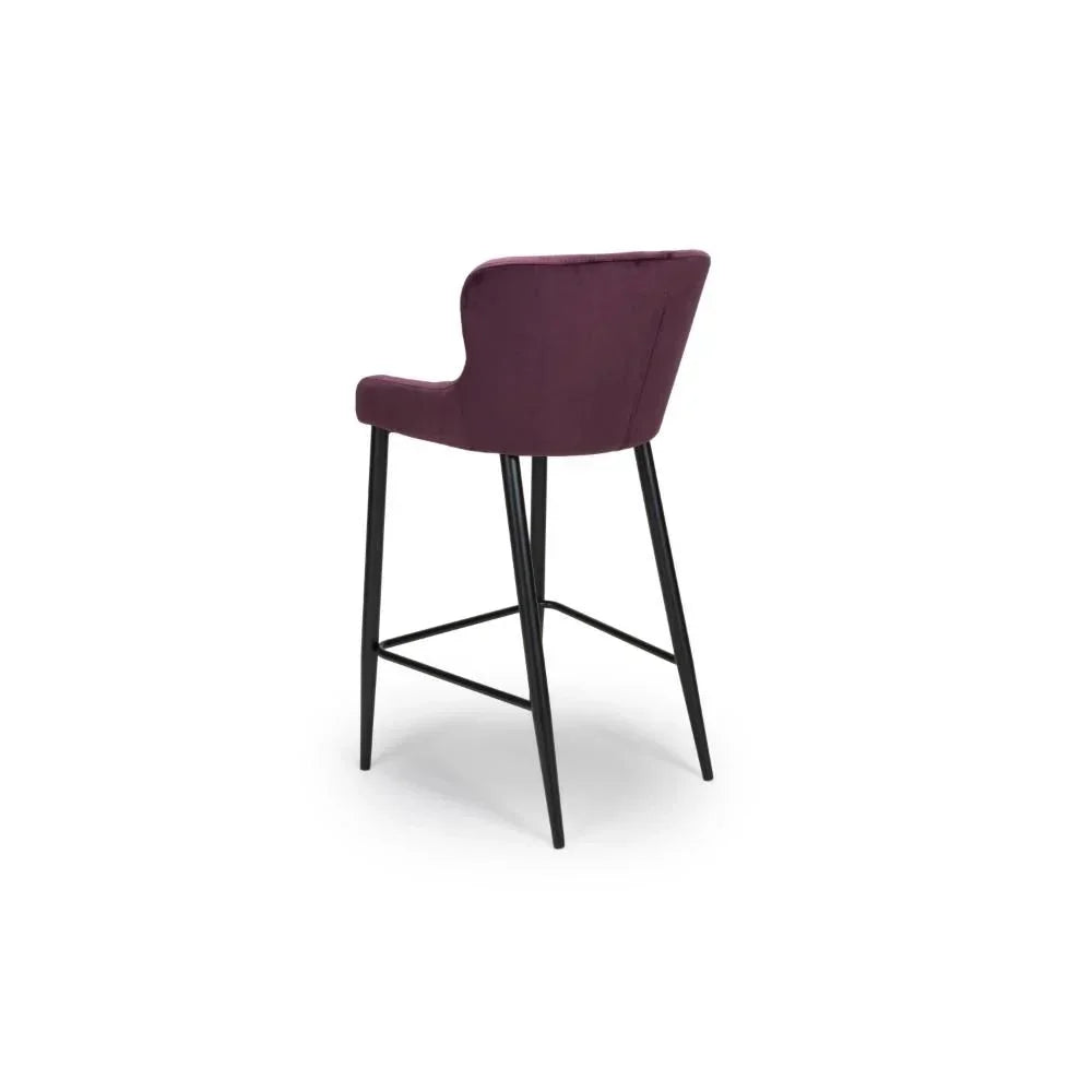 Plum velvet bar stool with curved backrest and black metal legs, rear angled view