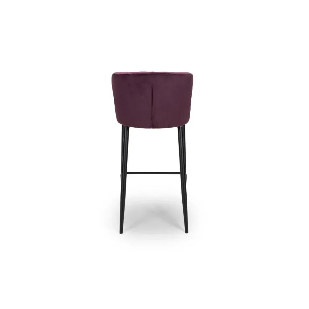 Back view of plum velvet bar stool with black metal legs on white background
