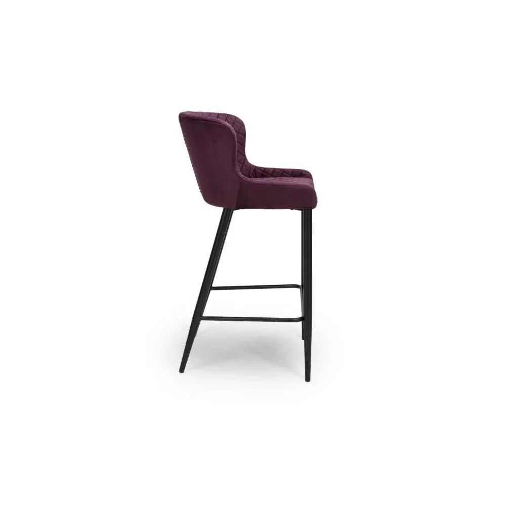 Plum velvet bar stool with quilted backrest and black metal legs, side profile view