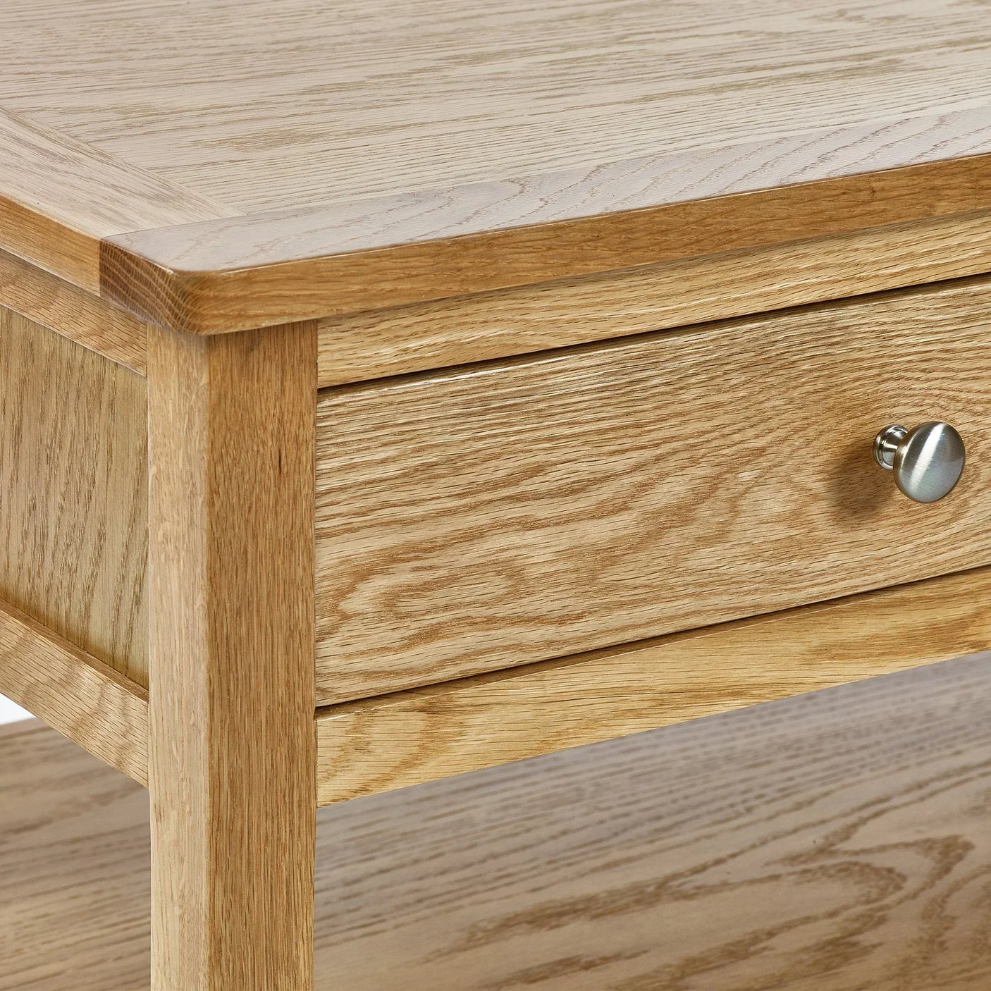 Oak coffee table with drawer and metal knob, showing detailed wood grain finish