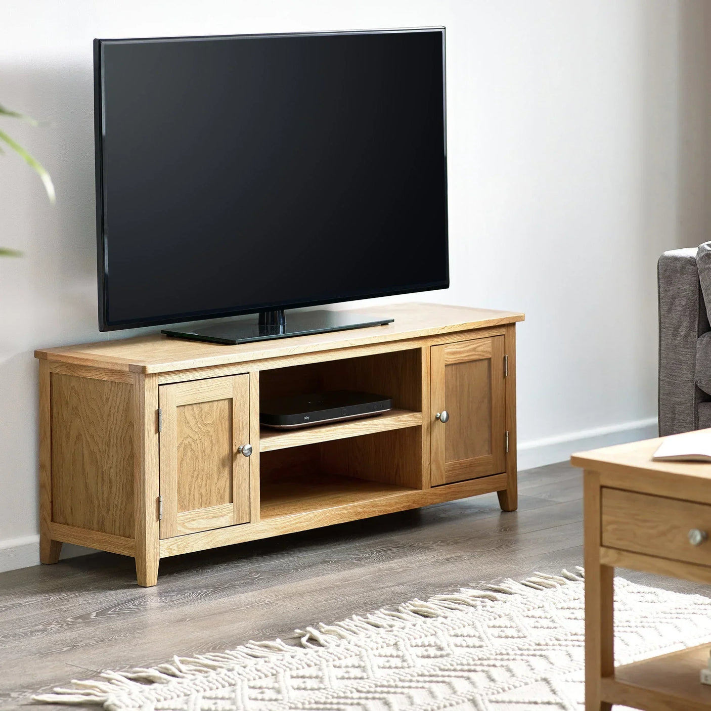 Oak TV unit with storage cabinets and open shelf in modern living room
