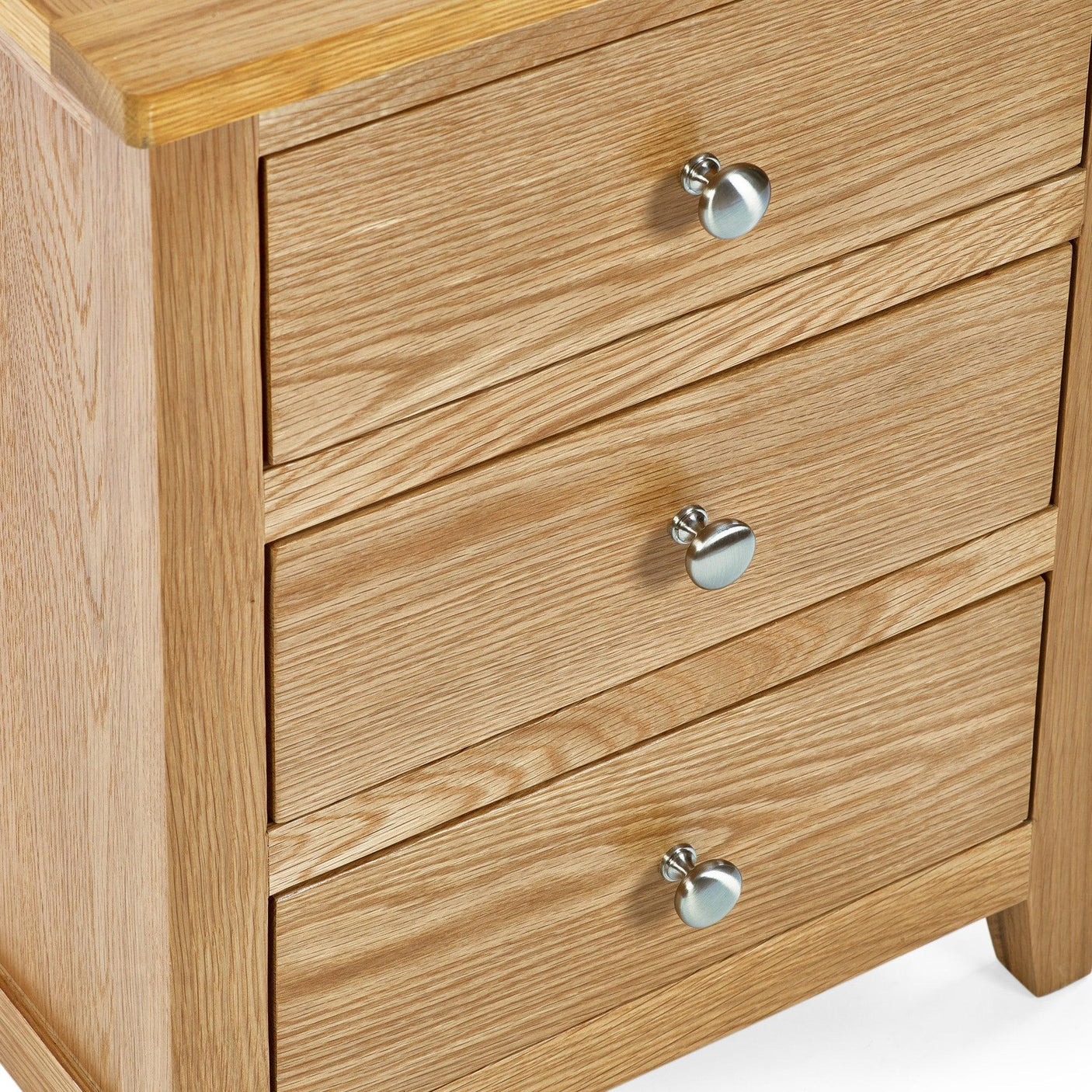 Oak 3 drawer bedside table with silver knobs closeup on wood grain and corner detail