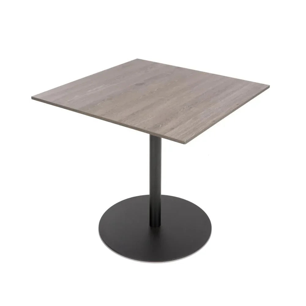 Square dining table with wood effect top and black pedestal base, angled view