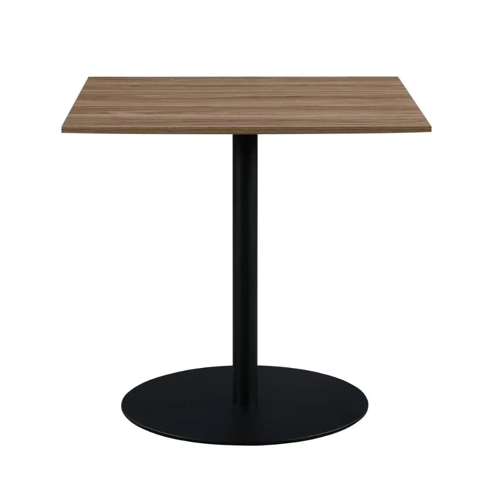 Square dining table with wood top and black metal pedestal base on white background