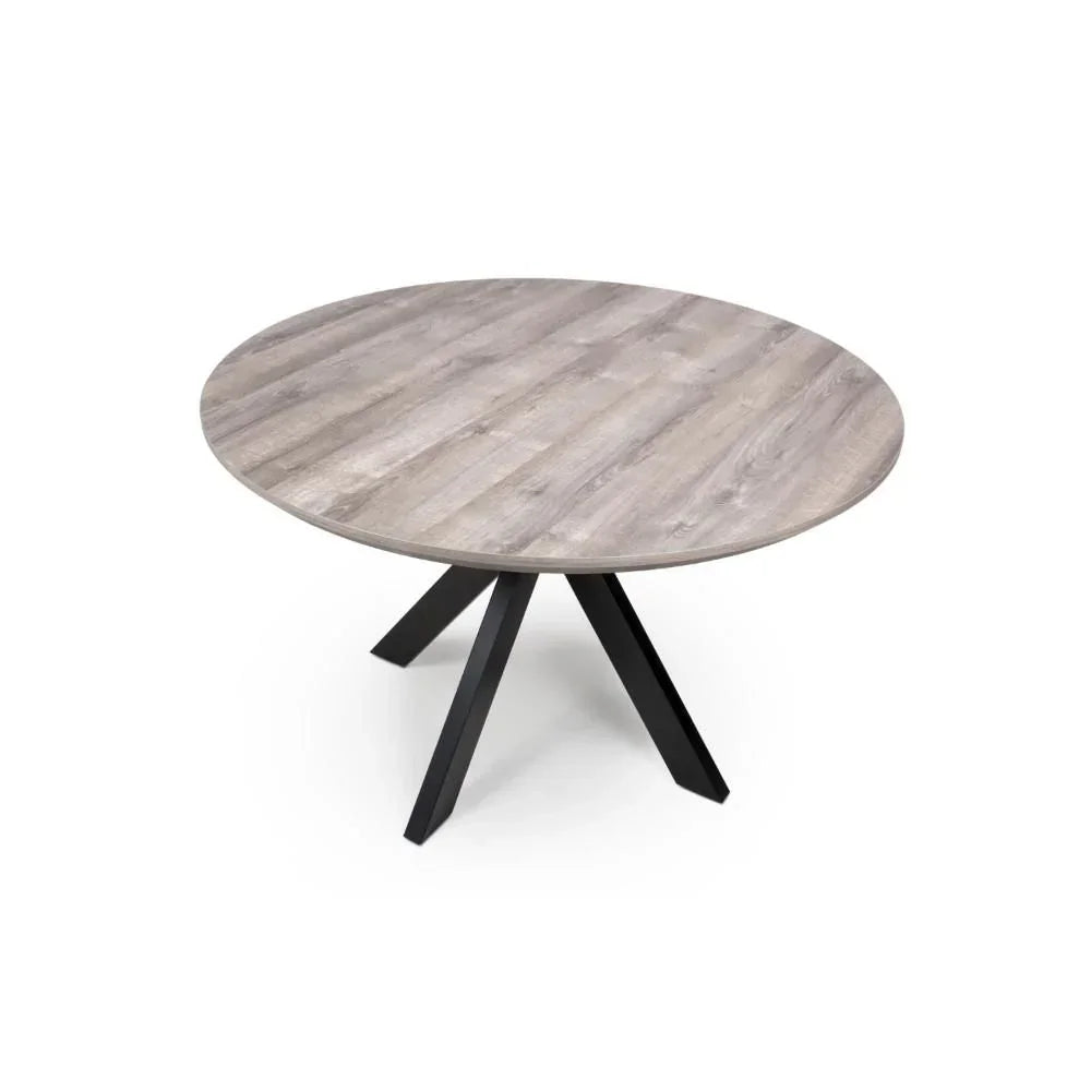 Round dining table with light wood top and black metal angled legs on white background